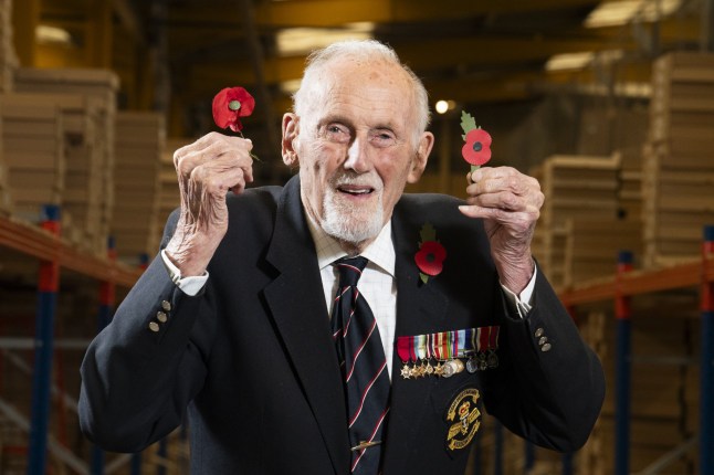 99-year-old D-Day veteran John Roberts, who served in the Royal Navy for 40 years, holding the new plastic-free paper poppy, the first redesign of the poppy for 28 years, at the Royal British Legion's Poppy Appeal Warehouse in Aylesford, for the launch of the Royal British Legion Poppy Appeal 2023. Picture date: Thursday October 26, 2023.