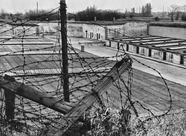 A high-angle view through barbed wire of the fourth courtyard at the Theresienstadt Ghetto, in the fortress town of Terez??n, German-occupied Czechoslovakia (Protectorate of Bohemia and Moravia), 1945. Red Army troops defeated the remaining German forces outside Theresienstadt on 8th May '45, after the Red Cross had taken over the administration of the camp on 2nd May. (Photo by Three Lions/Hulton Archive/Getty Images)
